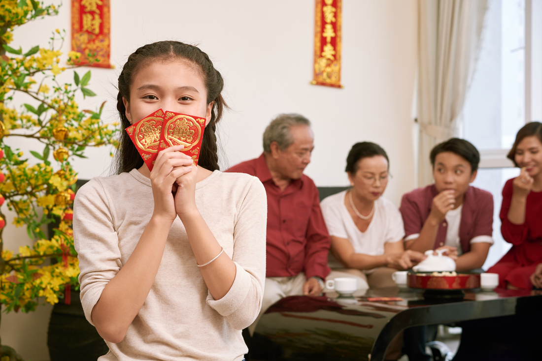 Post-Festive Acne during celebration. a girl hold angpow