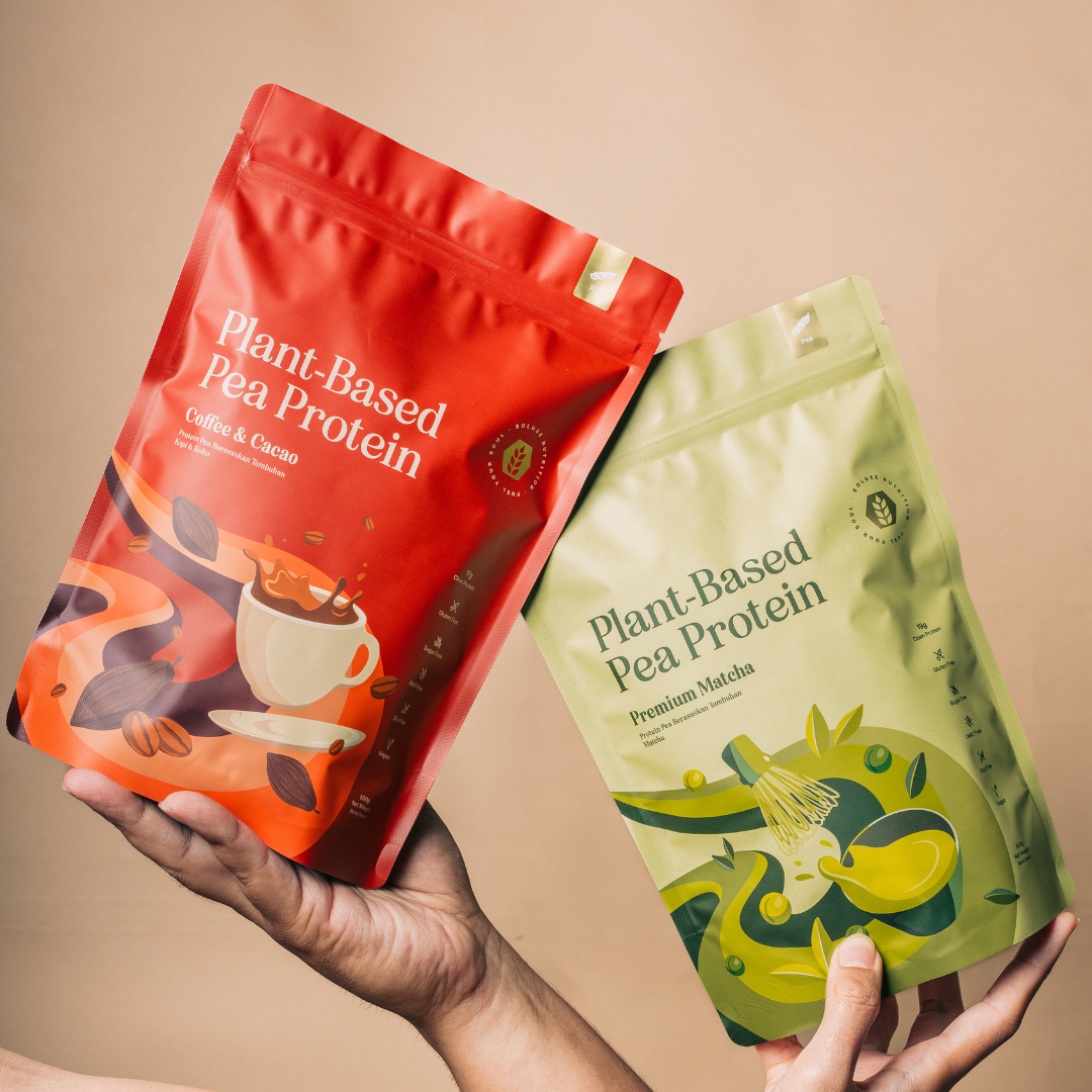 Two packages of plant-based pea protein powder with coffee cacao and match flavour flavour held by a person against a beige background