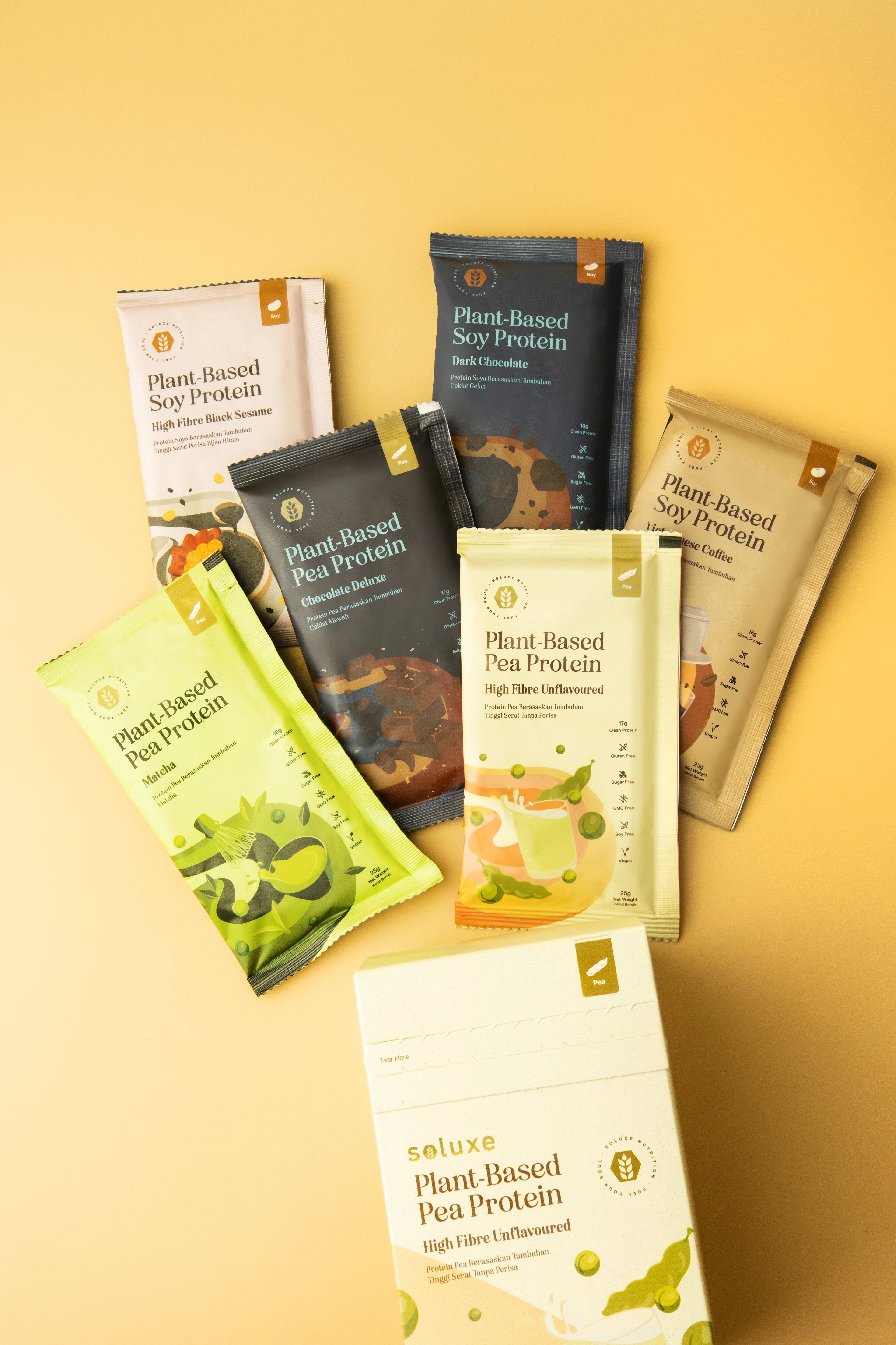 Assorted Pea and Soy Soluxe Plant-Based Protein Powder Sachet on the floor with box