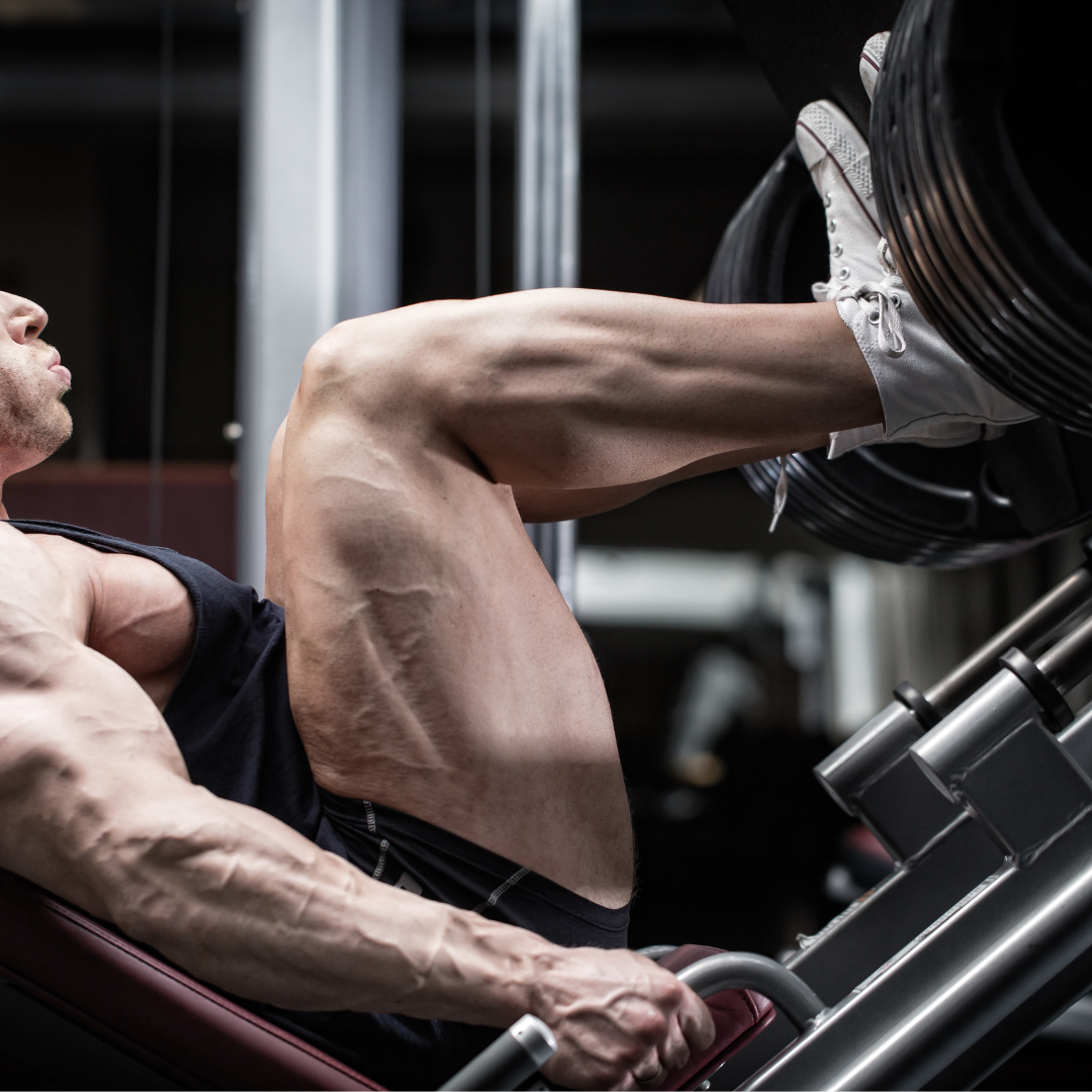 Muscular man exercising on a weight machine in a gym